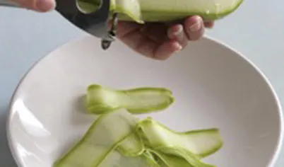Кабачки тонко нарежьте лентами при помощи ножа для чистки овощей.