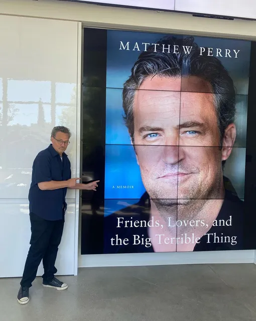 Мэттью Перри рядом с баннером, посвященном его мемуару