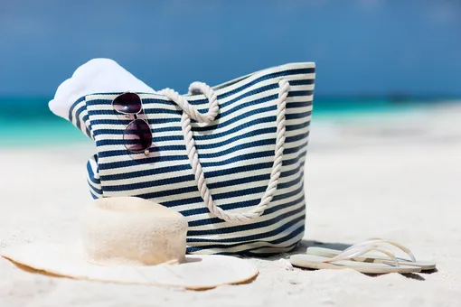 пляжная сумка, очки солнечные, шляпка и тапки на пляже