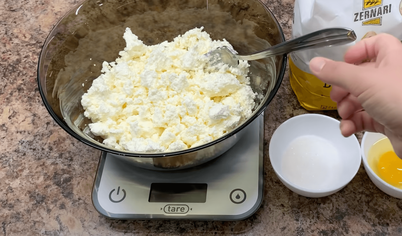 Замешиваем тесто для ленивых вареников. Для этого высыпаем творог в миску и добавляем к нему соль. Разминаем вилкой до одного состояния.
