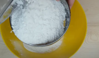 Просеиваем муку в миску, к ней добавляем соль, сахар, дрожжи и перемешиваем.