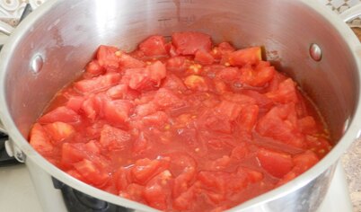 Нарезать помидоры небольшими кубиками и сложить в кастрюлю с толстым дном. 
Поставить на средний огонь, довести до кипения, уменьшить огонь до минимального и варить до выкипания жидкости 40-50 минут, периодически перемешивая.