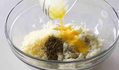 Далее смешайте остывшую цветную капусту, пармезан и размятую моцареллу, добавьте специи (чеснок, орегано, соль) и чуть взбитые яйца.

