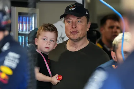 Илон Маск, генеральный директор X, SpaceX, Tesla, и его сын стоят в гараже команды Red Bull во время тренировки Гран-при Майами на международном автодроме Майами.