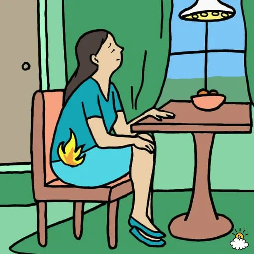 Женщина сидит за столом, причины газообразования в кишечнике у женщин